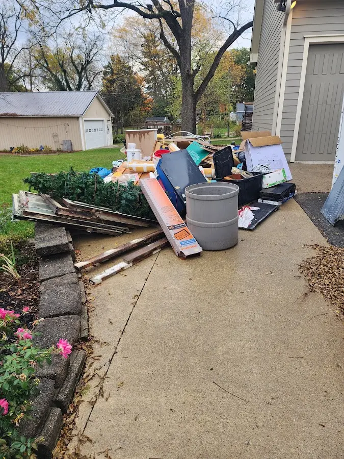 Dumpster being loaded with debris for Estate Cleanout Dumpster Rental in Walsenburg